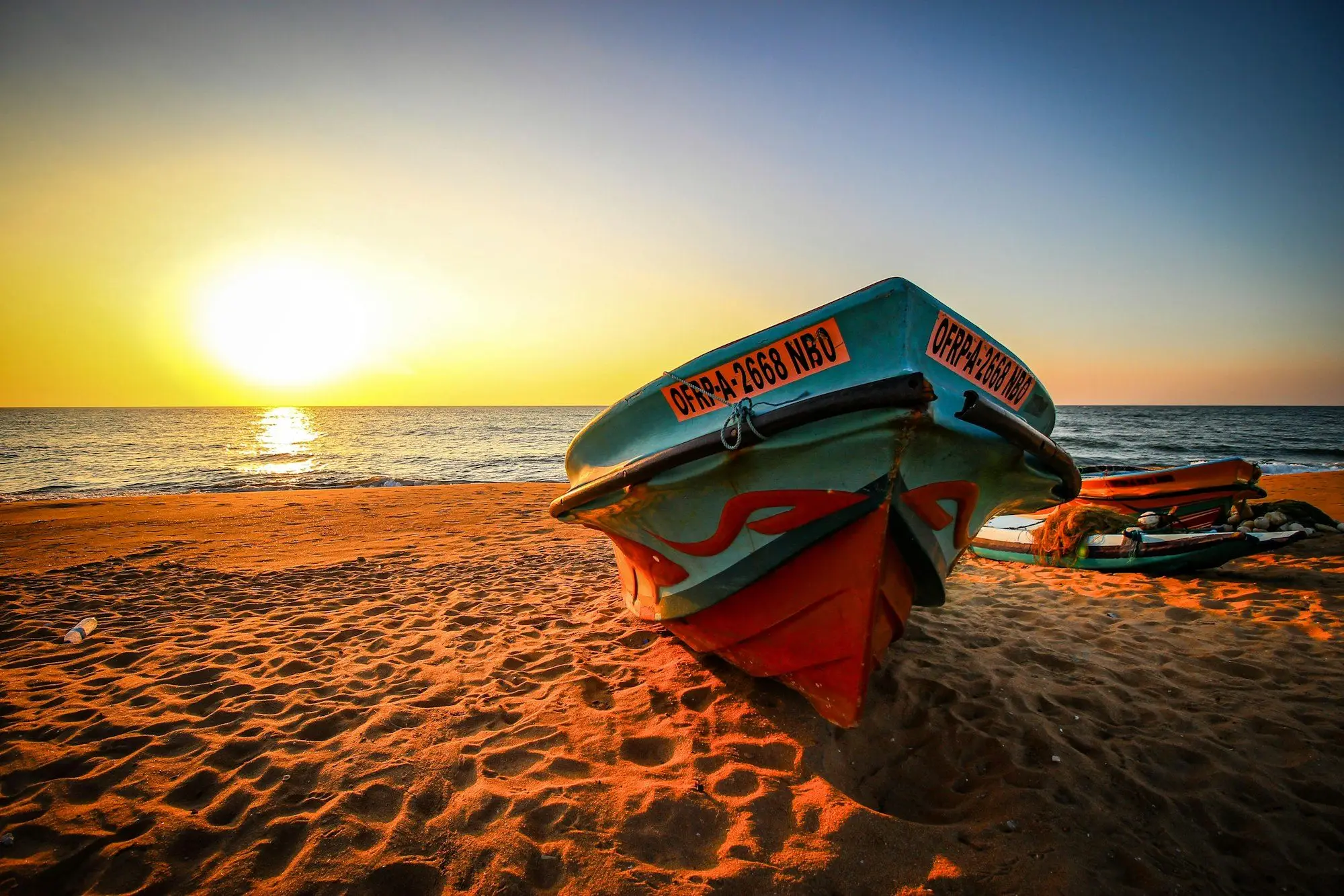 Fishing boat on Negombo beach at sunset