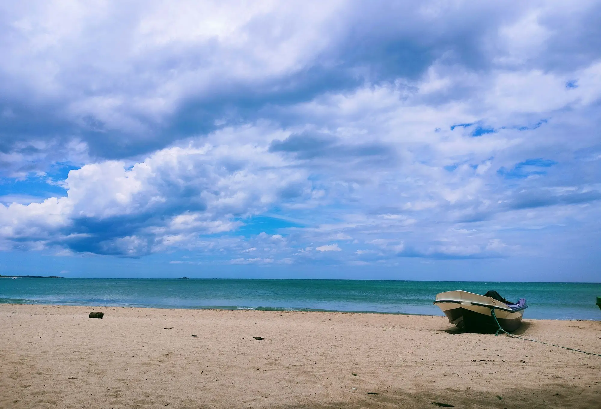 Boat on a quiet east-coast beach in Sri Lanka